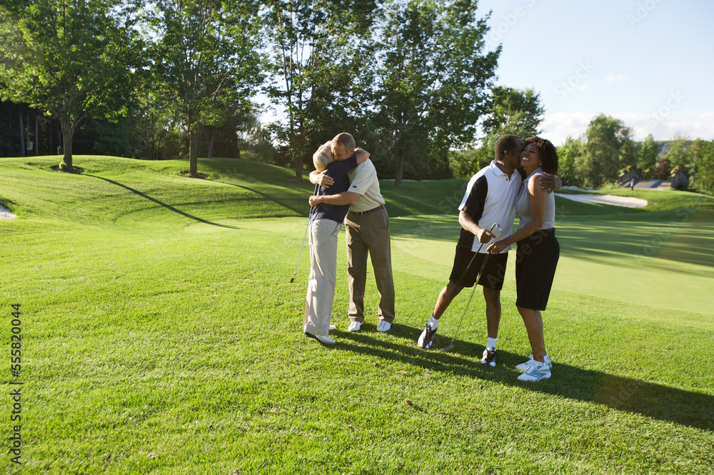 Couples Hugging on Golf Course, Burlington, Ontario, Canada Couples Hugging on Golf Course, Burlington, Ontario, Canada