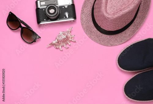 Tourist accessories on pink background. Top view. Flat lay. Copy space