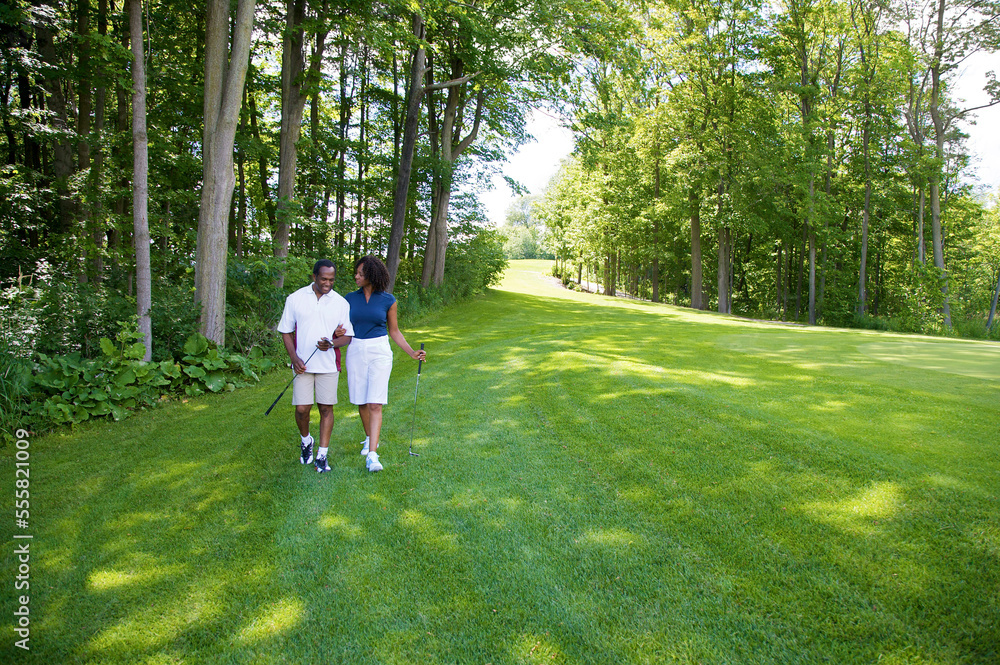 Couple Walking on Golf Course Couple Walking on Golf Course