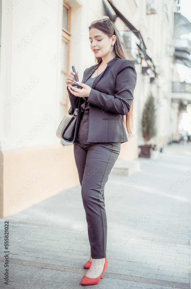 Young beautiful caucasian woman applying makeup with a brush in the city Young beautiful caucasian woman applying makeup with a brush in the city