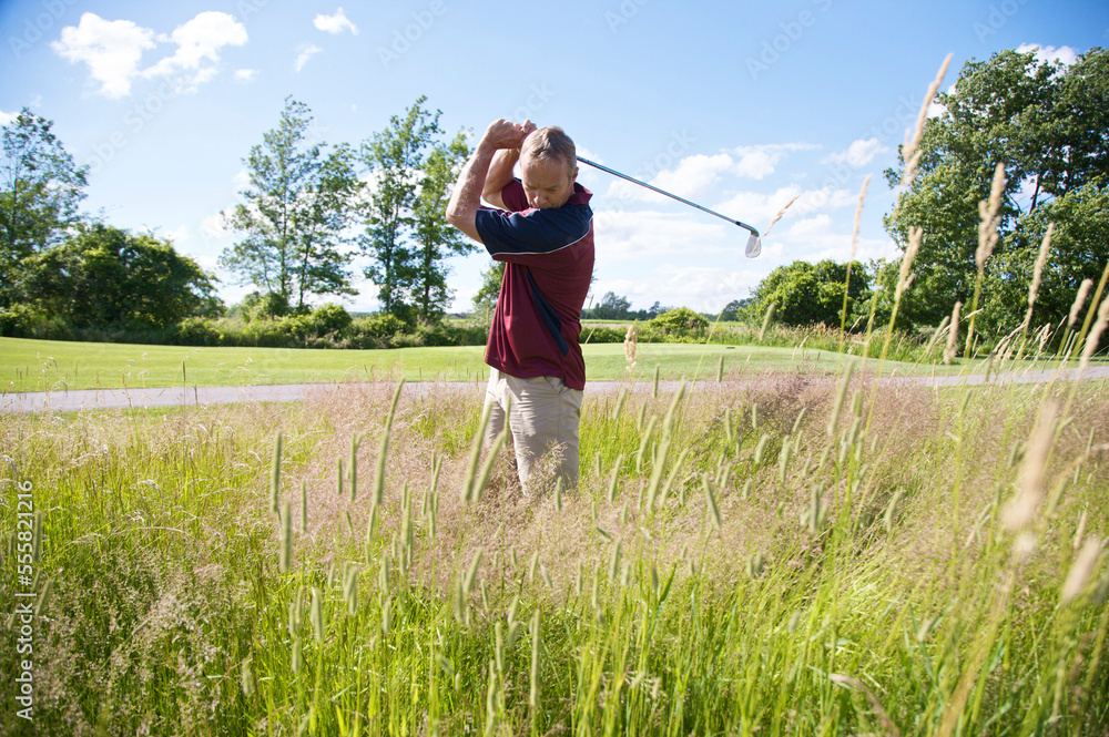Man Golfing in Tall Grass