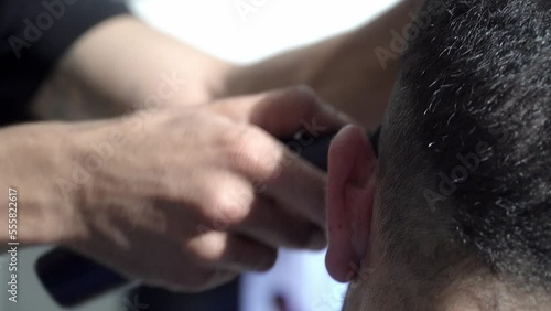 Men's hairstyling and hair cutting in salon. close up shot.