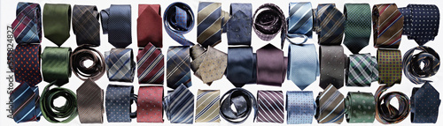 Assortment of ties rolled-up on white background in studio