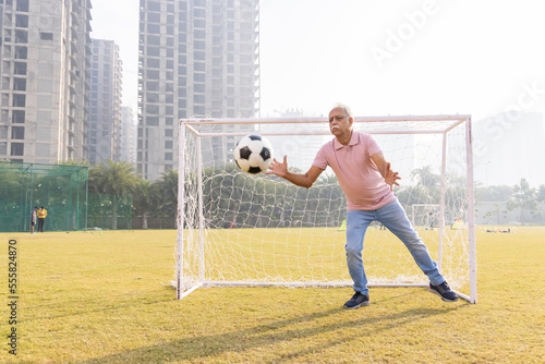 Canvas Print Senior Man Catching Football at Goal Net