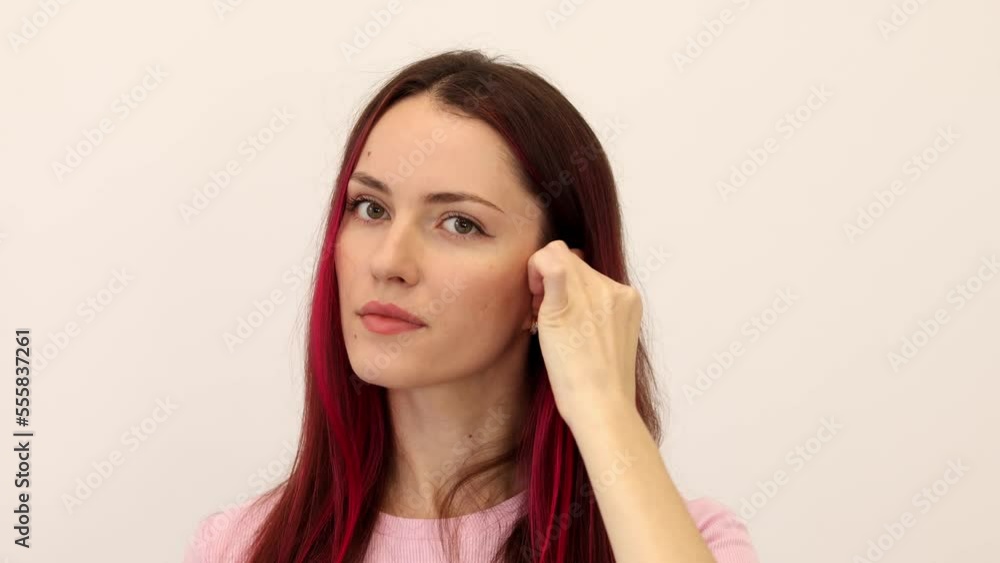 Woman puts earplugs in her ear. Girl uses earplugs to sleep peacefully. Earplugs are a piece of soft plastic that is inserted into your ear canal to protect your ears from loud sounds, water, wind or Woman puts earplugs in her ear. Girl uses earplugs to sleep peacefully. Earplugs are a piece of soft plastic that is inserted into your ear canal to protect your ears from loud sounds, water, wind or