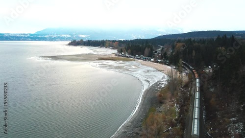 Wallpaper Mural During the winter months near Salmon Arm, British Columbia, Canada, this aerial view of the railway next to Shuswap Lake shows the train traveling along the railway as it passes by. Torontodigital.ca