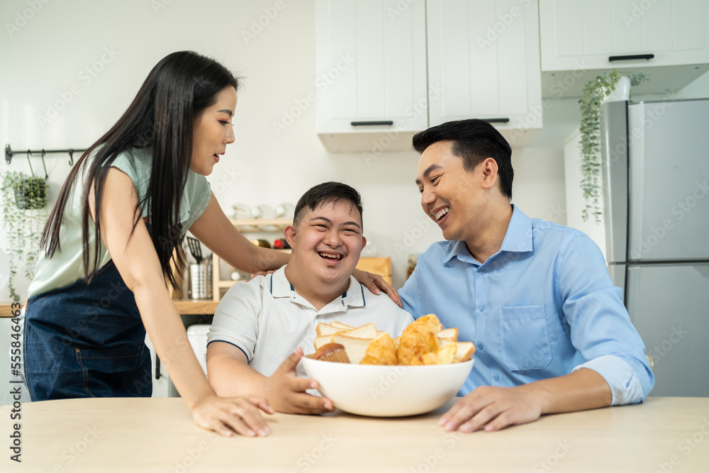 Asian happy family, mature parents baking bakery with son in kitchen. Asian happy family, mature parents baking bakery with son in kitchen.