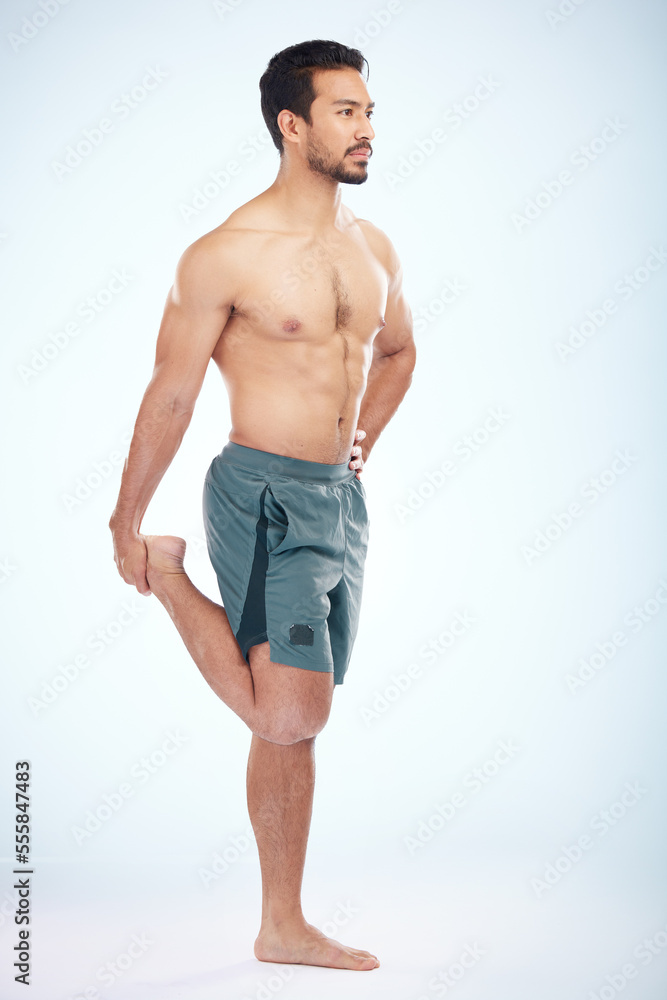Fototapeta premium Fitness, health and man stretching leg in studio isolated on a blue background mock up. Sports, body wellness and young male athlete stretch, warm up and preparing for workout, exercise and training.