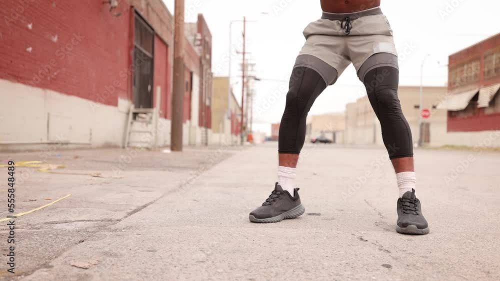 Athletic African American man with a deformed left hand working out with a battle rope in a warehouse area near downtown Los Angeles. Athletic African American man with a deformed left hand working out with a battle rope in a warehouse area near downtown Los Angeles.