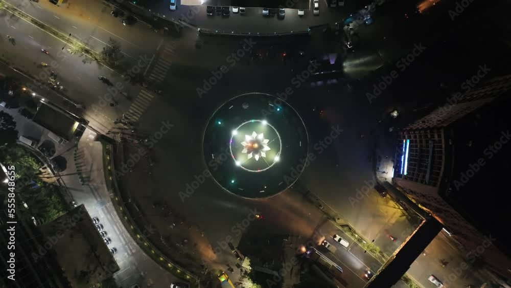 Aerial view of vehicles driving a roundabout with a circle fountain in Dhaka downtown, Bangladesh. Aerial view of vehicles driving a roundabout with a circle fountain in Dhaka downtown, Bangladesh.