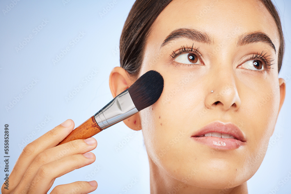 Woman, face and thinking with makeup brush for skincare beauty, luxury skin wellness and cosmetics dermatology in studio. Facial care, product application or spa vision aesthetic in blue background Woman, face and thinking with makeup brush for skincare beauty, luxury skin wellness and cosmetics dermatology in studio. Facial care, product application or spa vision aesthetic in blue background