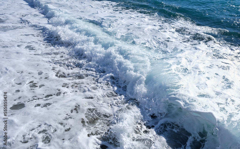 Fototapeta premium Wave hitting the beach in the sea.