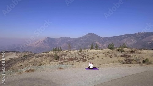 Aerial of Woman Doing Yoga on Top of Beautiful California Mountain Landscapes photo