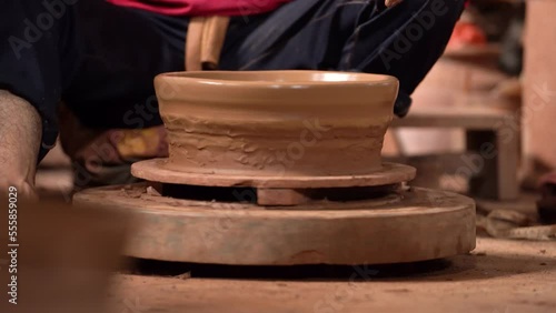 The process of forming or making pottery from clay in the form of flower pots, jugs, piggy banks, and others, located in Kasongan, Bantul, Indonesia. photo