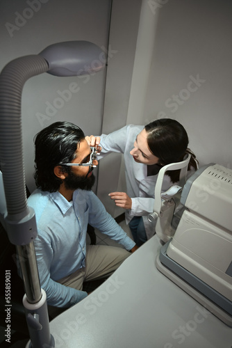 Ophthalmologist checking eye vision of patient for appropriate spectacles glasses. Eye health check and ophthalmology concept