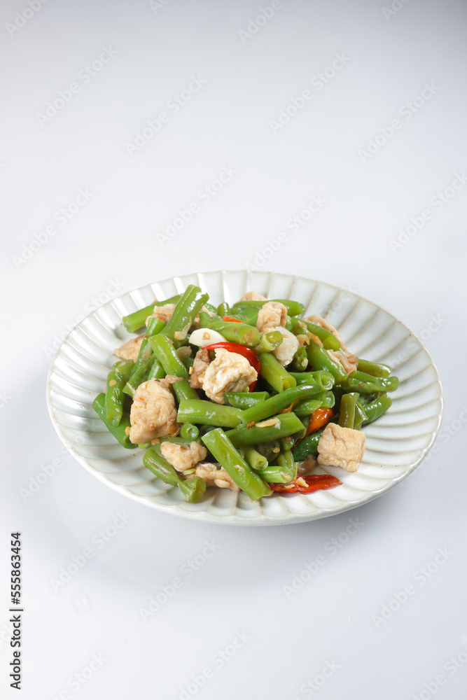 Oseng or Tumis Buncis is stir fry bean with fried tofu. Oseng or Tumis Buncis is stir fry bean with fried tofu.