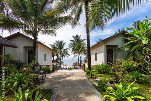 Paradise tropical luxury hotel resort with bungalows and palm trees on territory