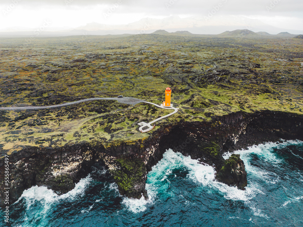 Aerial view of orange Svortuloft Lighthouse by the sea in West Iceland highlands, Snaefellsnes peninsula