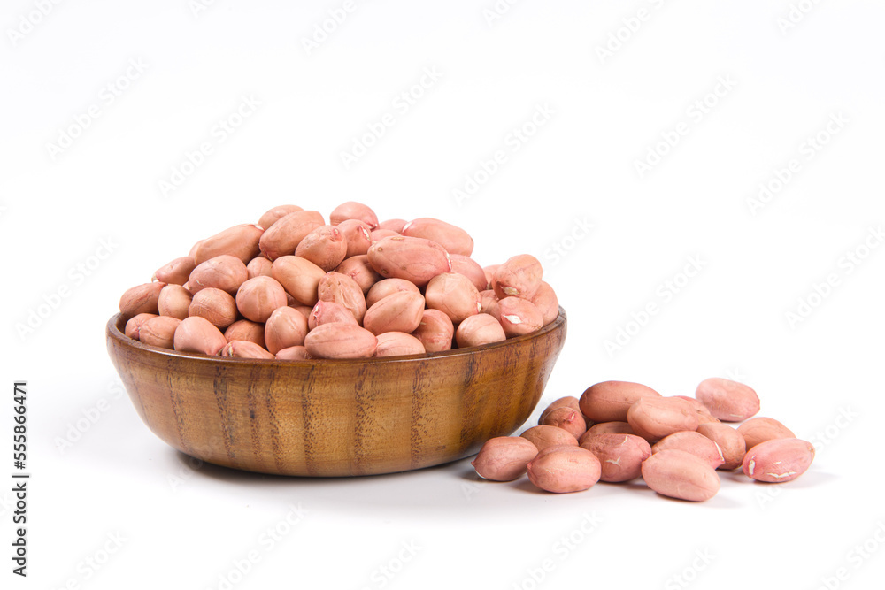Raw peanuts in a wooden plate isolated on white background. Raw peanuts in a wooden plate isolated on white background.