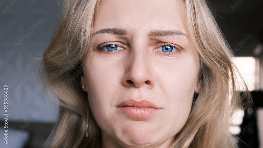 Portrait of crying grieving woman of 30 years. Grimace of sadness with tears in her eyes and crooked chin of blonde woman looking at camera. Emotional swing, unstable psyche, mental problems Portrait of crying grieving woman of 30 years. Grimace of sadness with tears in her eyes and crooked chin of blonde woman looking at camera. Emotional swing, unstable psyche, mental problems