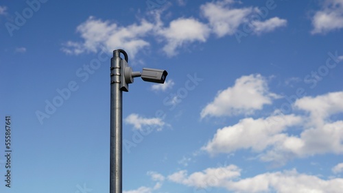 video surveillance camera against cloudy sky