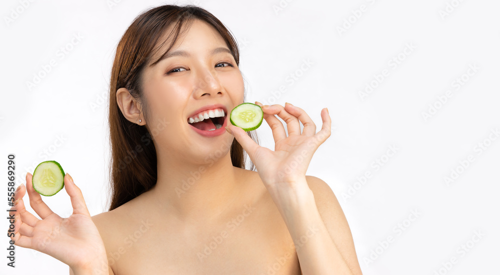 Asian woman fresh and bright face skin using cucumber slices to spa treatment and skin care white background. Beauty and salon. Asian woman fresh and bright face skin using cucumber slices to spa treatment and skin care white background. Beauty and salon.