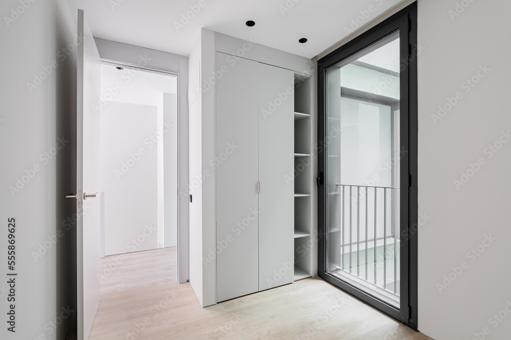 Modern style entrance hall interior, neutral white color corridor with  wooden light parquet floor, sliding wardrobe and glass door in black  aluminum frame with access to the street. Stock Photo | Adobe