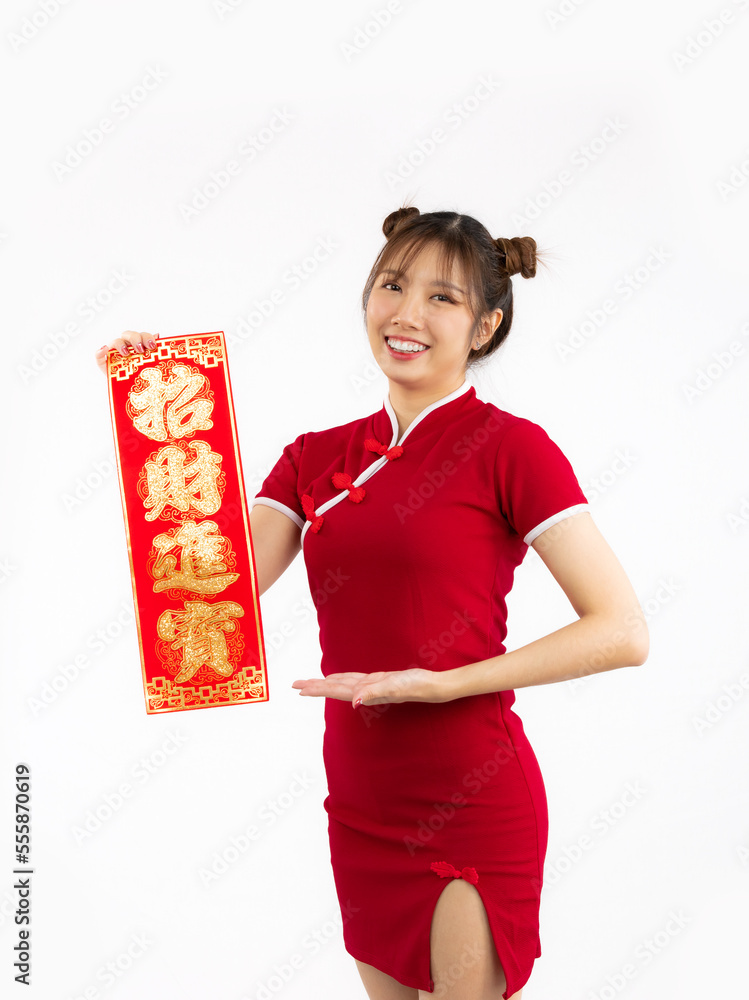 Young Asian woman in red traditional cheongsam dress presenting Chinese new year label and looking at camera isolated white background. Young Asian woman in red traditional cheongsam dress presenting Chinese new year label and looking at camera isolated white background.