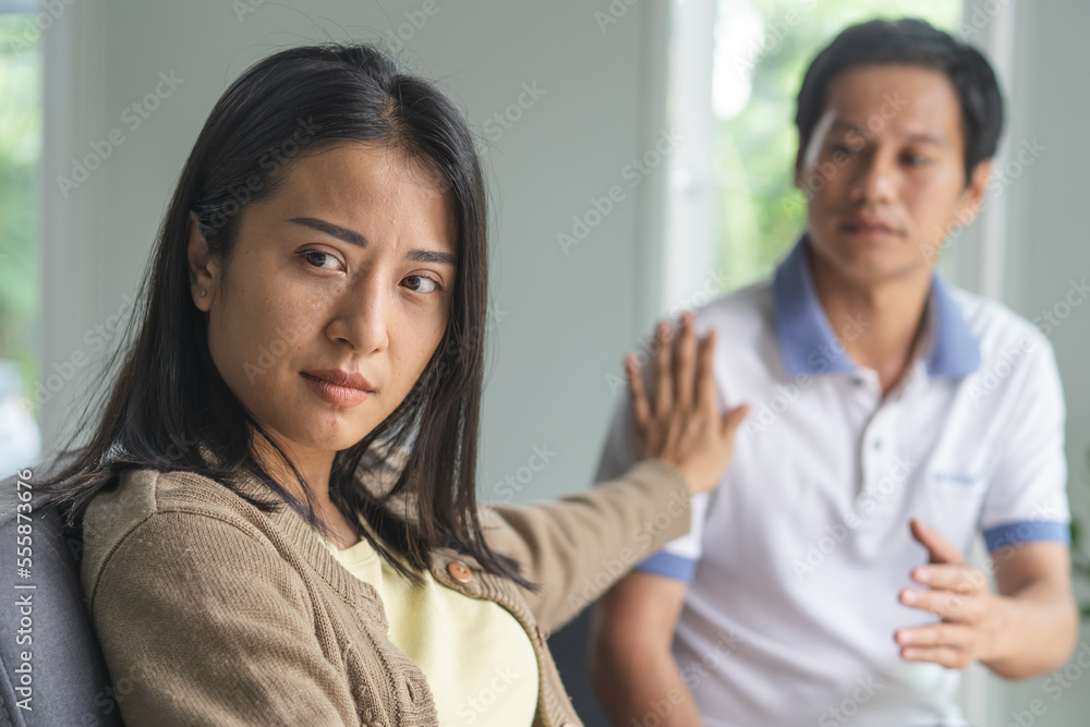 Asian couple having relation problem. Sadness wife stop husband to talk to her at home after quarrel. Asian couple having relation problem. Sadness wife stop husband to talk to her at home after quarrel.