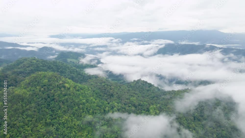 Drone fly above the fog over the mountain in cloudy day Drone fly above the fog over the mountain in cloudy day