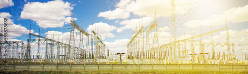 Slika na platnu power plant and transformer towers close-up in the steppe, against the blue sky
