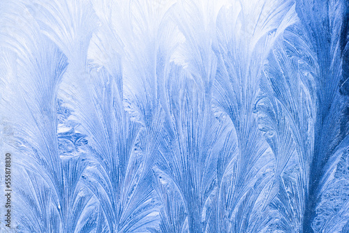 texture applied by severe frost on glass in the early frosty morning, the background is blurred