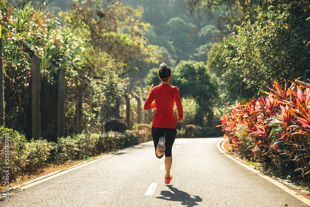 Obraz premium Healthy lifestyle woman runner stretching legs in morning park