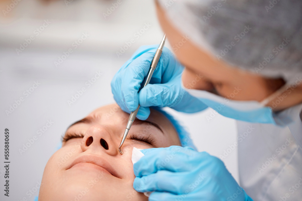 woman during a mechanical face cleansing procedure woman during a mechanical face cleansing procedure