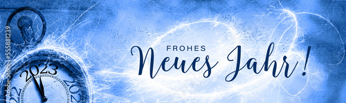 Frohes neues Jahr 2023 - Happy New Year Greeting card with German text, Silvester clock, fireworks and snow - Panorama, banner, header with copy space - Abstract background, New year´s eve 