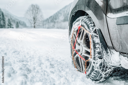 Snow chains on tire at winter snowy road