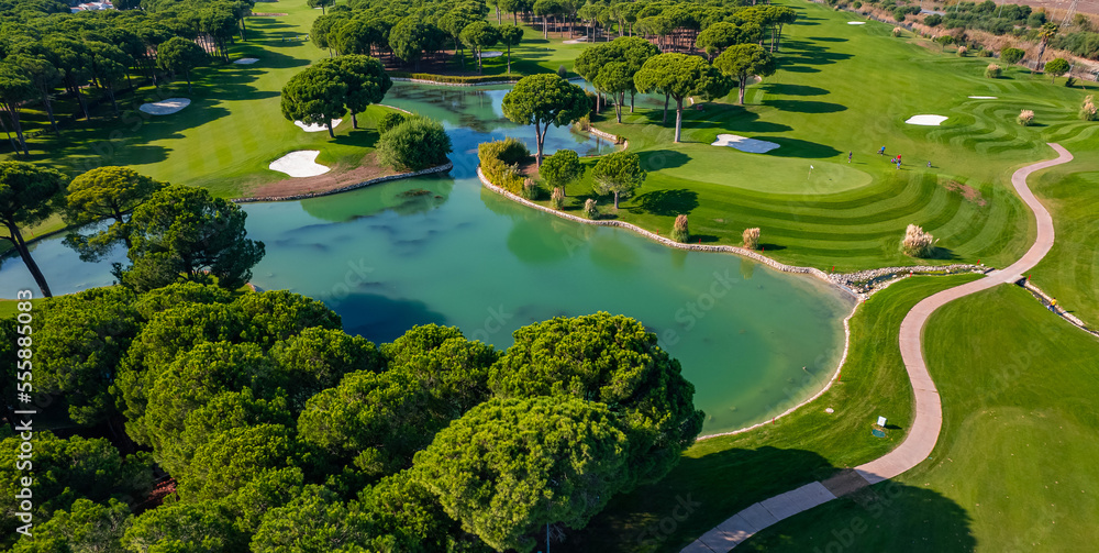 Obraz premium Luxury Green golf course field with lake Antalya Belek Turkey, aerial top view
