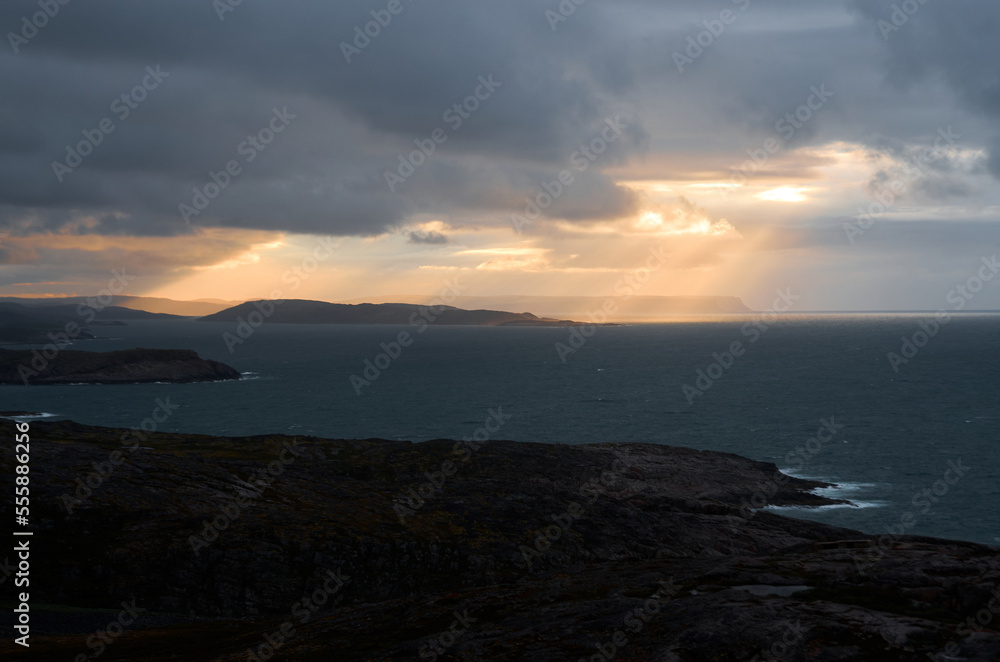 Dramatic cloudy sunset over the turbulent northern sea