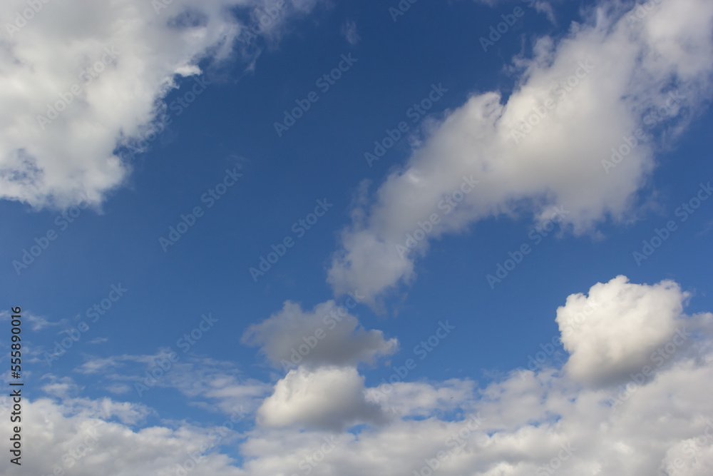 clouds in the sky lit by the sun on a summer day. background clouds in the sky lit by the sun on a summer day. background