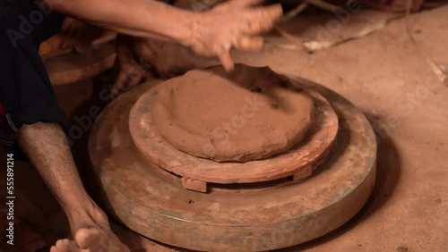 The process of forming or making pottery from clay in the form of flower pots, jugs, piggy banks, and others, located in Kasongan, Bantul, Indonesia. photo