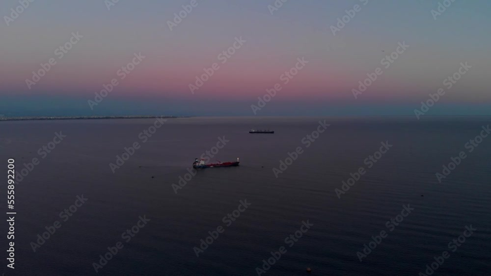 Aerial view of a tanker moving or parked at sea at night. Cargo ships on the high seas at sunset at night. High quality 4k footage Aerial view of a tanker moving or parked at sea at night. Cargo ships on the high seas at sunset at night. High quality 4k footage
