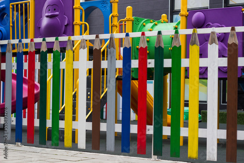 Children's fence made of different colors of wooden crayons
