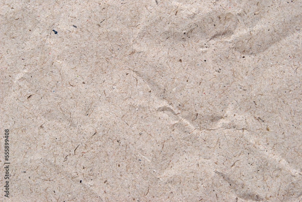 A sheet of beige crumled recycled paper texture as background A sheet of beige crumled recycled paper texture as background