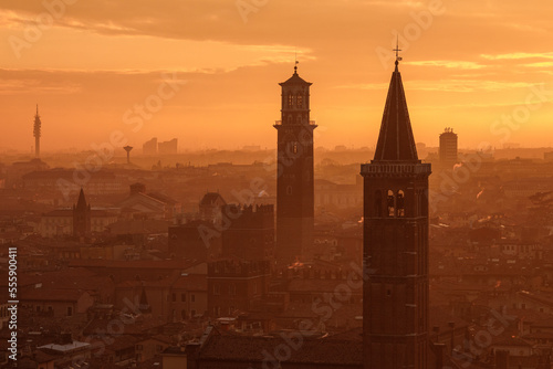 Fantastic picturesque view to Verona and river Adige in flame sundown haze from Castle San Pietro