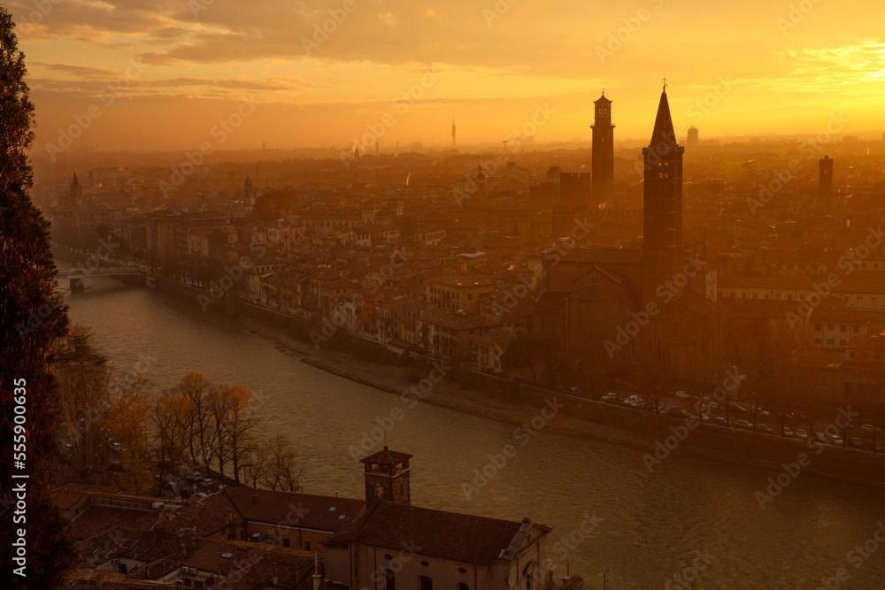 Fantastic picturesque view to Verona and river Adige in flame sundown haze from Castle San Pietro