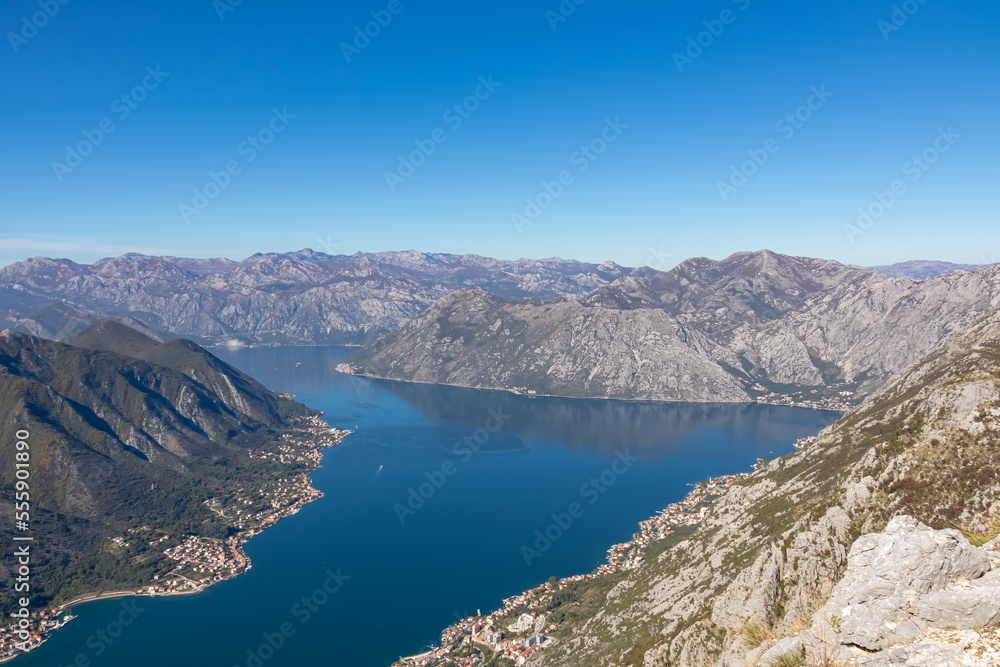 Panoramic view from Pestingrad (Derinski Vrh) of Kotor bay in sunny summer, Adriatic Mediterranean Sea, Montenegro, Balkan Peninsula, Europe. Fjord winding along coastal towns. Lovcen, Orjen mountains Panoramic view from Pestingrad (Derinski Vrh) of Kotor bay in sunny summer, Adriatic Mediterranean Sea, Montenegro, Balkan Peninsula, Europe. Fjord winding along coastal towns. Lovcen, Orjen mountains