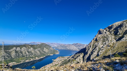 Panoramic view of the bay of Kotor during sunrise in summer, Adriatic Mediterranean Sea, Montenegro, Balkan Peninsula, Europe. Fjord winding along the coastal towns. Lovcen and Orjen mountain range