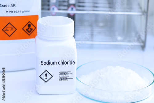 Фотография Sodium chloride in bottle , chemical in the laboratory and industry