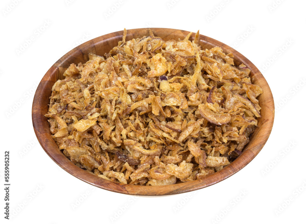 Side view of dried fried onions with salt in a wood bowl isolated on a white background. Side view of dried fried onions with salt in a wood bowl isolated on a white background.