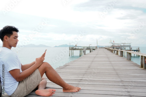 Wallpaper Mural A handsome freedom man relaxing on a book reading on the beach. Torontodigital.ca